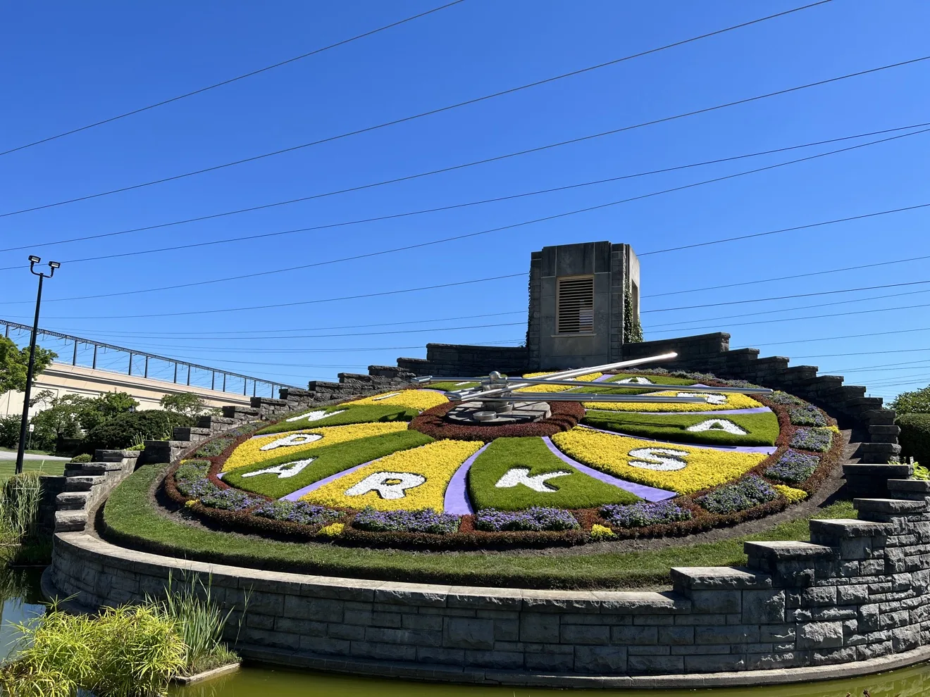 The Niagara Parks Floral Clock in full: flower face, stone tower and NIAGARA PARKS spelled in plants