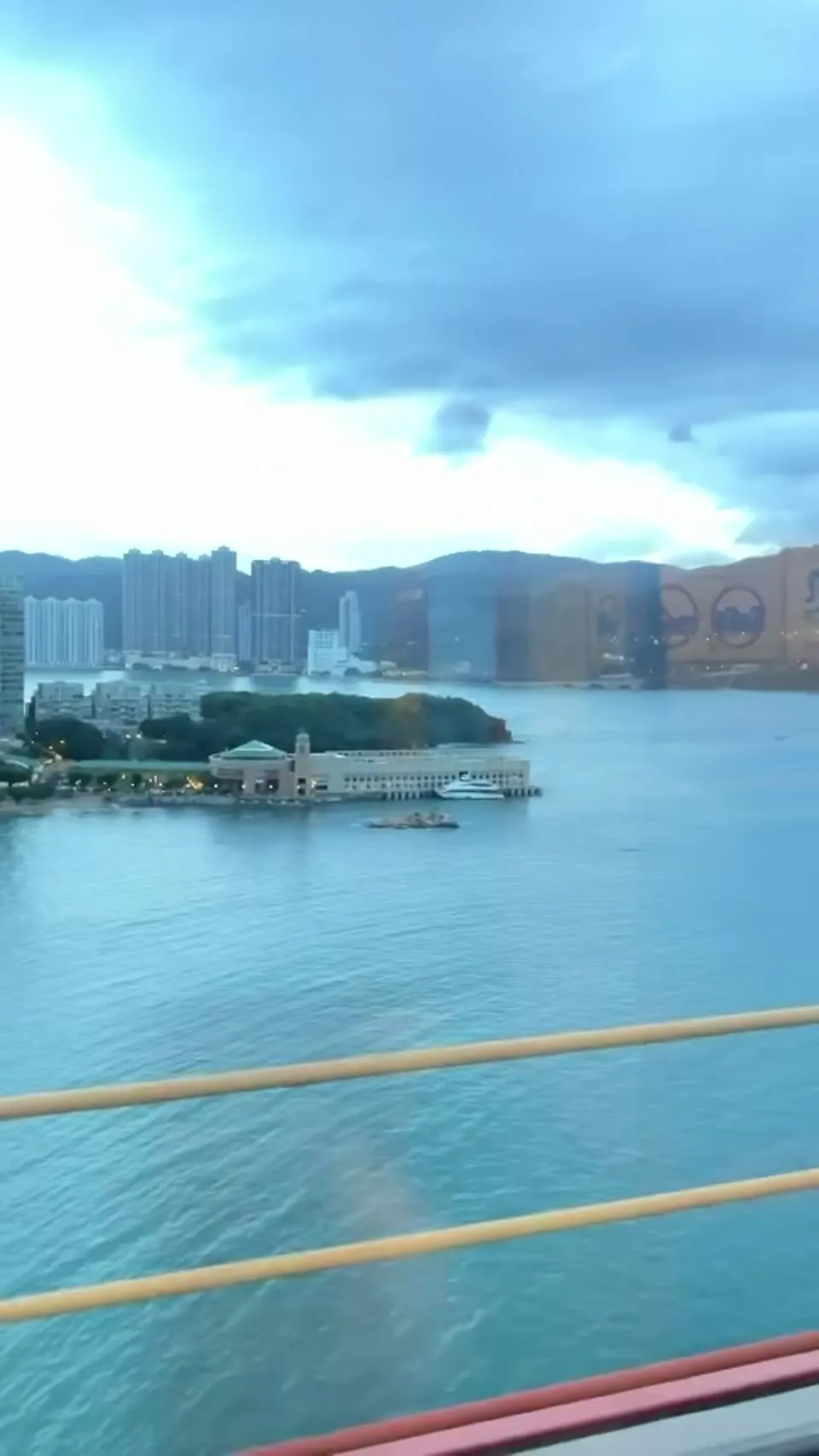 Harbour and residential towers passing the car window from a bridge
