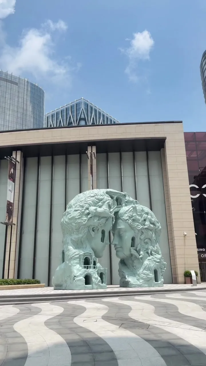 Kiss sculpture of two facing faces outside City of Dreams Macau