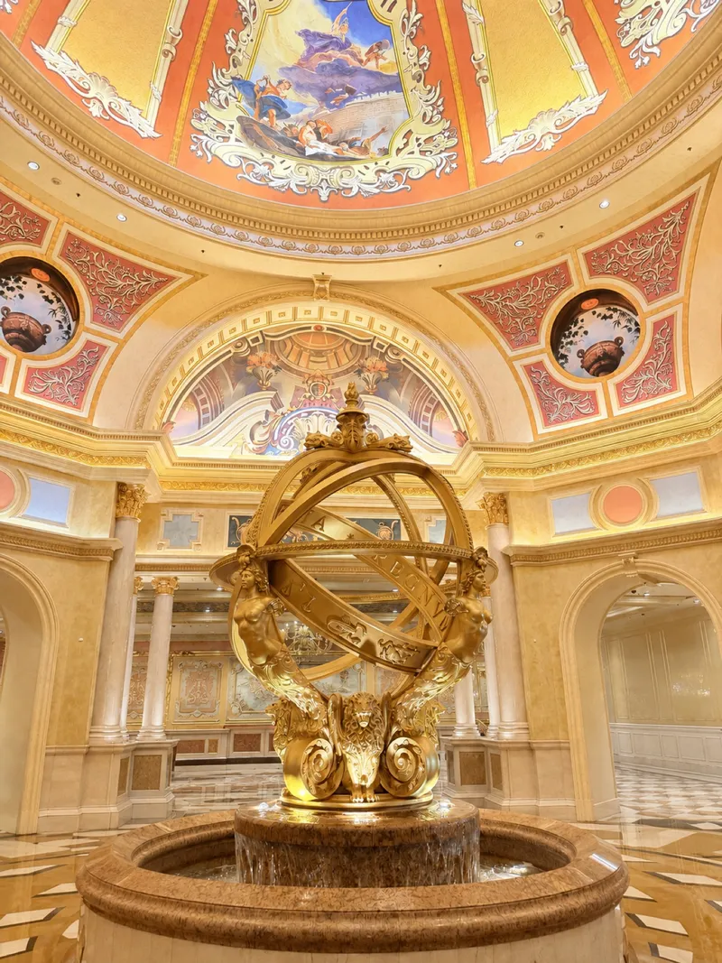 Golden armillary under the ornate Venetian Macao lobby dome