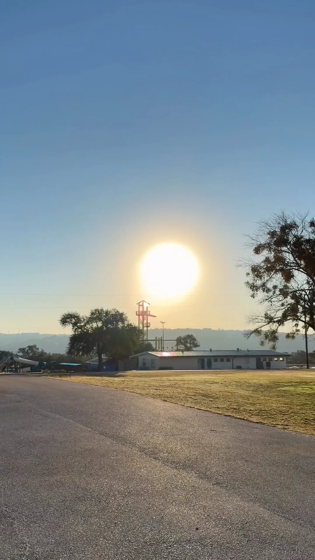 Sunrise over the cabins and tower at Highland Lakes Camp