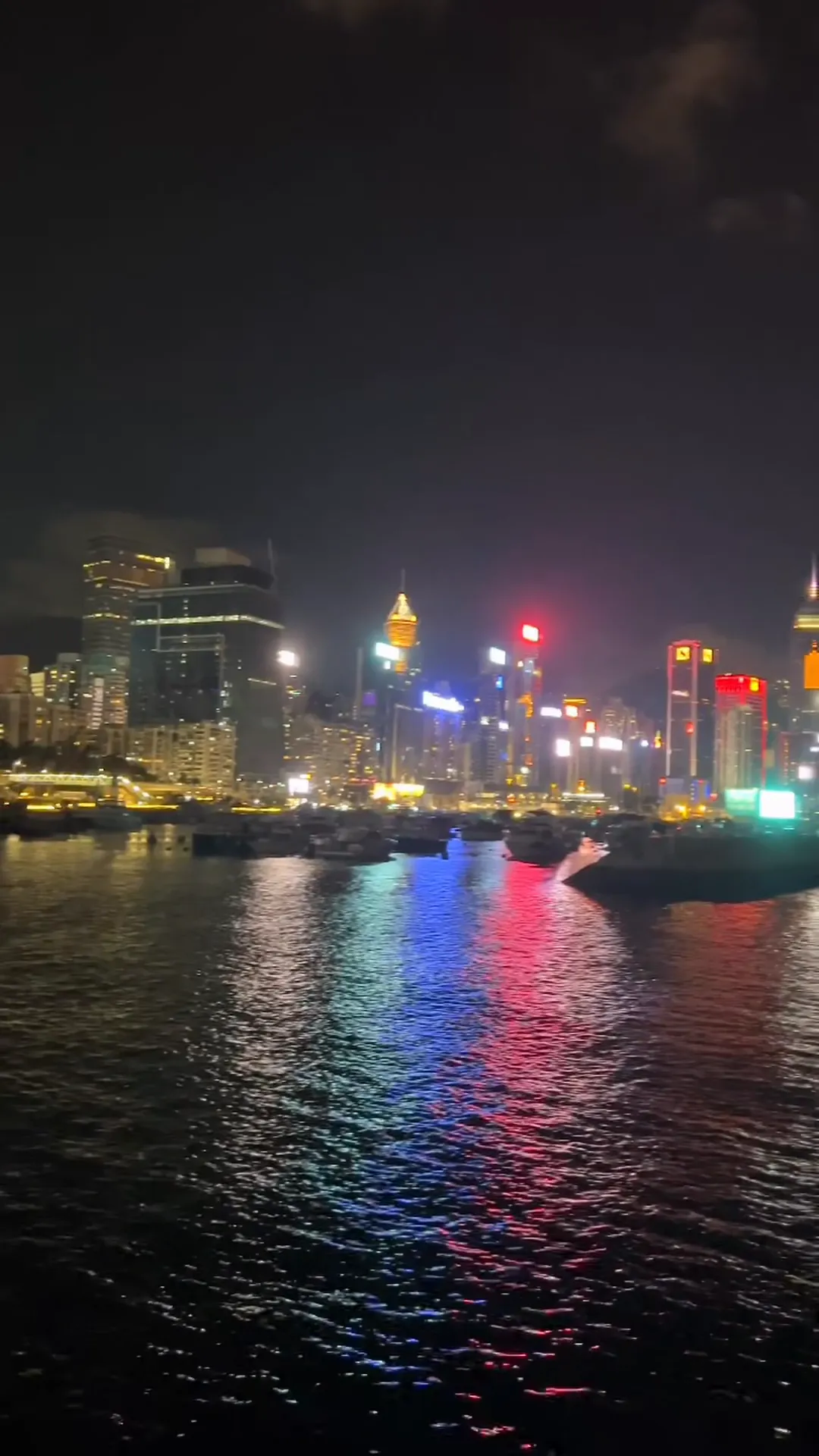 A harbour at night, city lights reflected on dark water